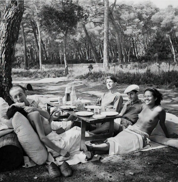 A group of people sitting around a picnic table.