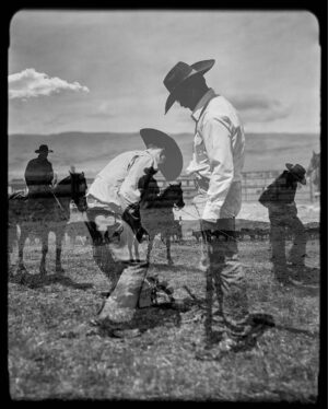 A black and white photo of two men in cowboy hats.