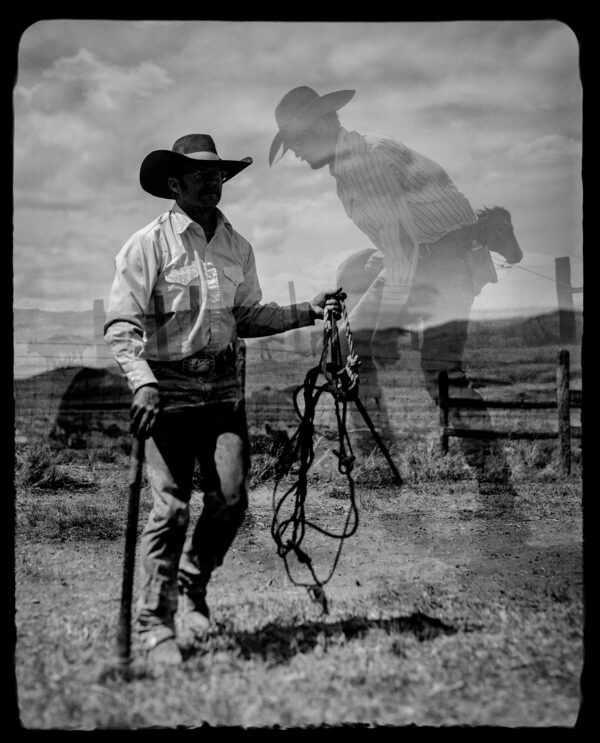 A man holding onto a horse in the middle of an open field.
