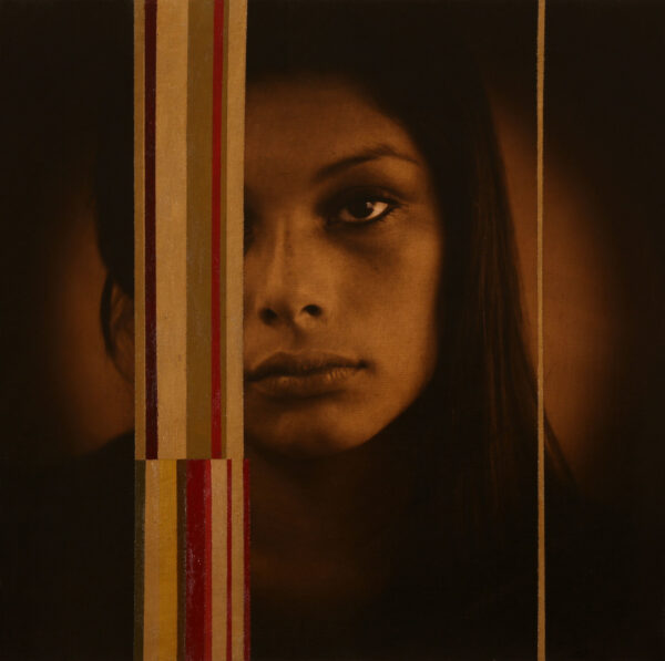 A woman with long hair is looking at the camera.