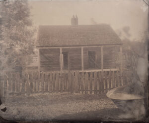 A black and white photo of an old house.