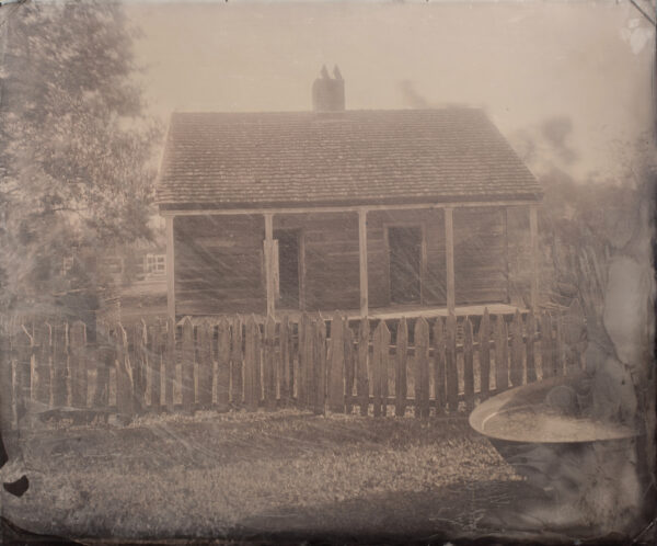 A black and white photo of an old house.