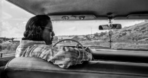 LYNN ADLER. Gerald in his car